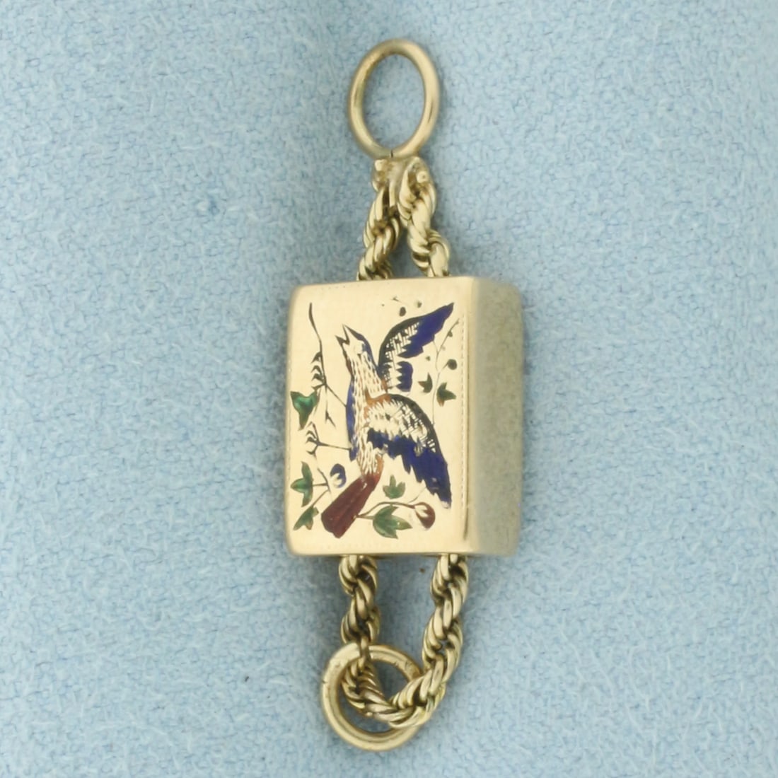 Antique Enameled Bird Charm in 14k Yellow Gold: In 14k Yellow Gold. 1 3/8 inch long. 3/8 inch wide. Colorful enamel bird design.