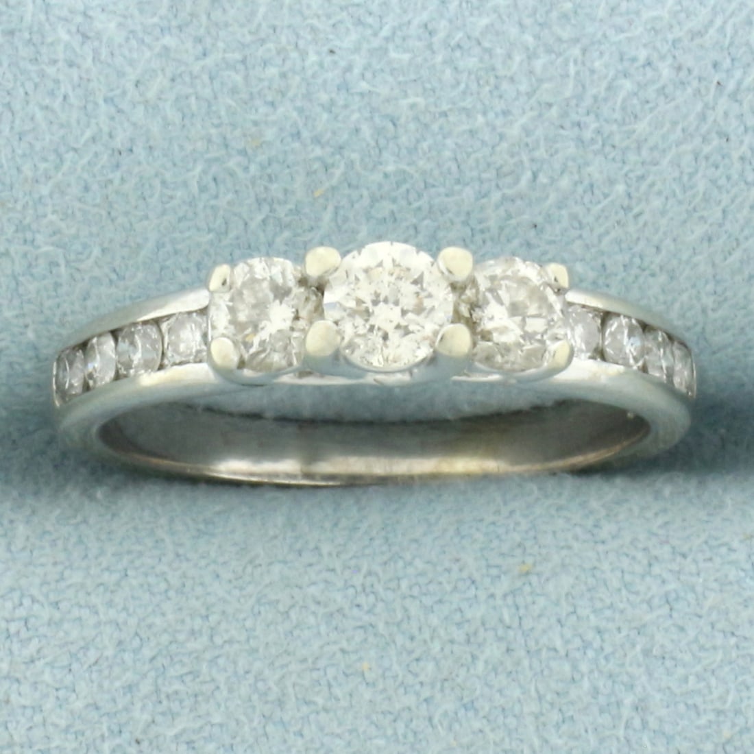 3-Stone Accented Diamond Engagement Ring in 10k White Gold: In 10k white gold. Center diamond is high quality 1/4ct round brilliant, H color/I clarity, great cut for lots of sparkle. Side diamonds are high quality .18 ct each of similar high quality. Contains 