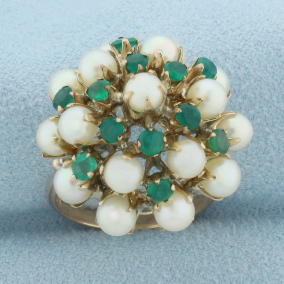Vintage Emerald and Akoya Pearl Cocktail Ring in 14k Yellow Gold: In 14k Yellow Gold. Contains seventeen 4.3mm high quality cultured akoya pearls with high luster. Also contains twelve 2.5mm high quality natural Emerald gemstone, with intense color. Size 7. 6.9g.