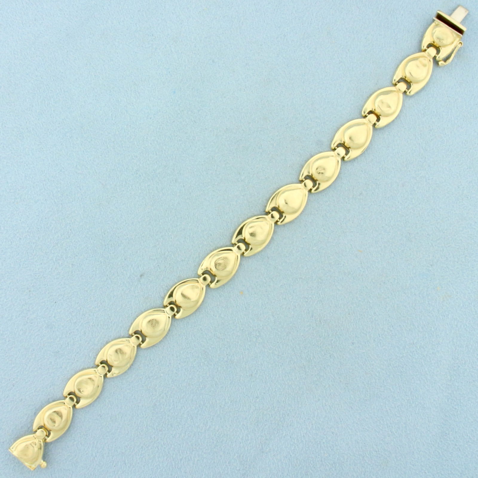 Abstract Designer Link Bracelet in 14K Yellow Gold: In 14K Yellow Gold. 7 inches long, 9.7mm wide. Safety clasp. Some links have small dents in them, does not take away from beautiful of bracelet, they blend into design. 10.0g.