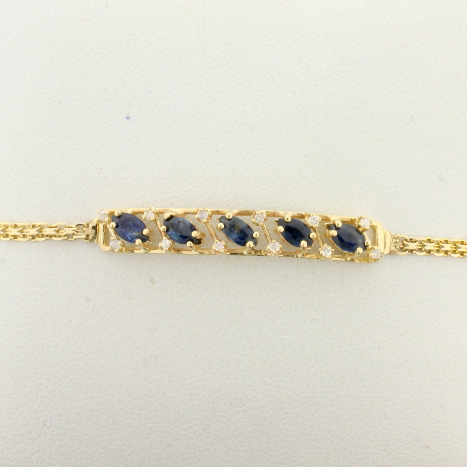 Sapphire and Diamond Bar Bracelet in 14K Yellow Gold: In 14K Yellow Gold. Contains five 5mm high quality natural marquise cut Sapphires with intense blue color and excellent clarity. Also contains twelve high quality .01ct diamonds, SI clarity/G color. 7