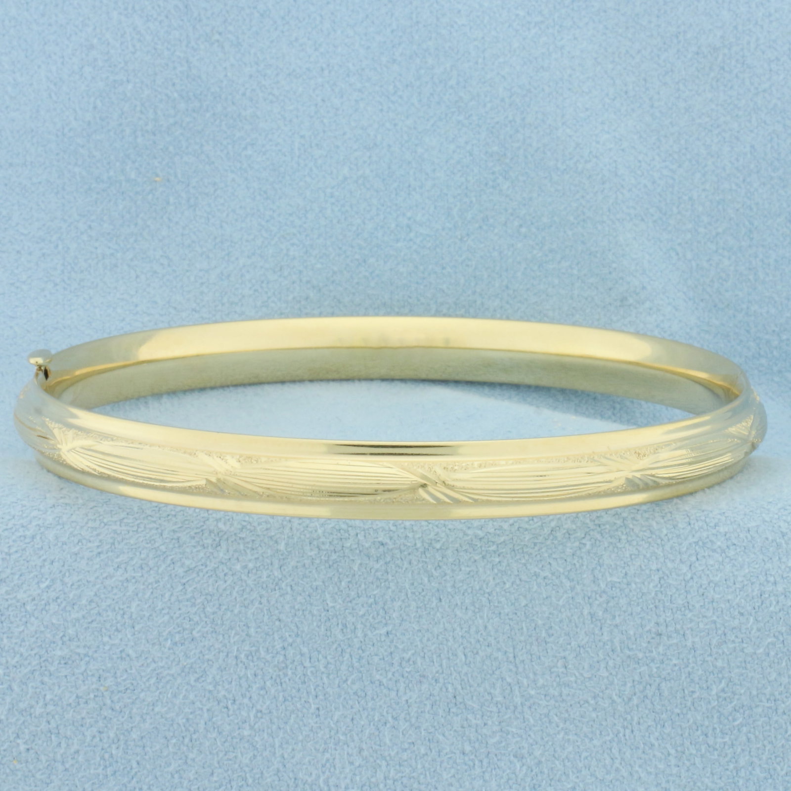 Etched Design Hinged Bangle Bracelet in 14k Yellow Gold: In 14k yellow gold. 6mm wide. Inner dimension 2 1/4 inches by 2 1/8 inches. Hinged slide opening for easy putting on/taking off. 7.8g.