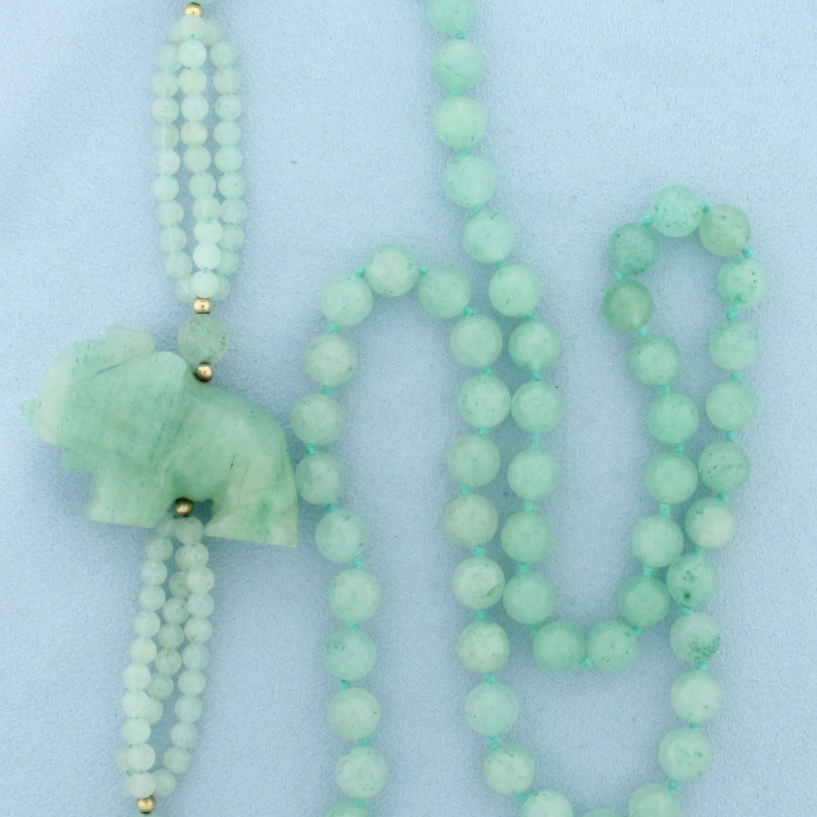 Jade Elephant and Gold Bead Necklace: 14k Yellow Gold Beads. 32 inches long. Most jade beads are 8mm. 3mm gold beads. 1 3/4 inch by 1 1/8 inch jade elephant. Hand knotted. 93.3g.