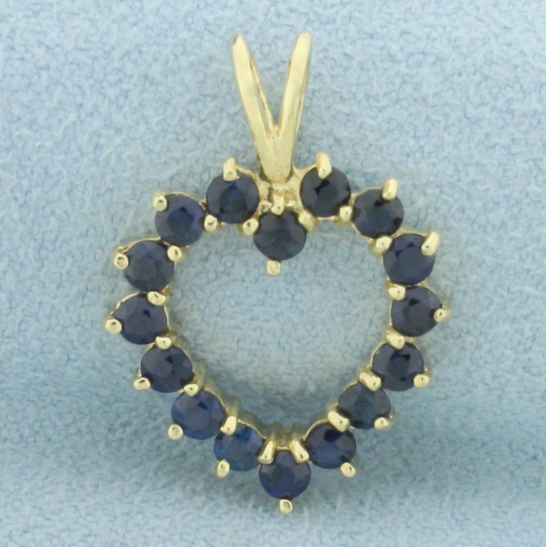 Sapphire Heart Pendant in 14k Yellow Gold: In 14K yellow gold. Contains 16 high quality natural sapphire gemstones, 3/4ct TW, with deep color and excellent clarity. Split V bale design. 7/8 inches long. 1.8g.