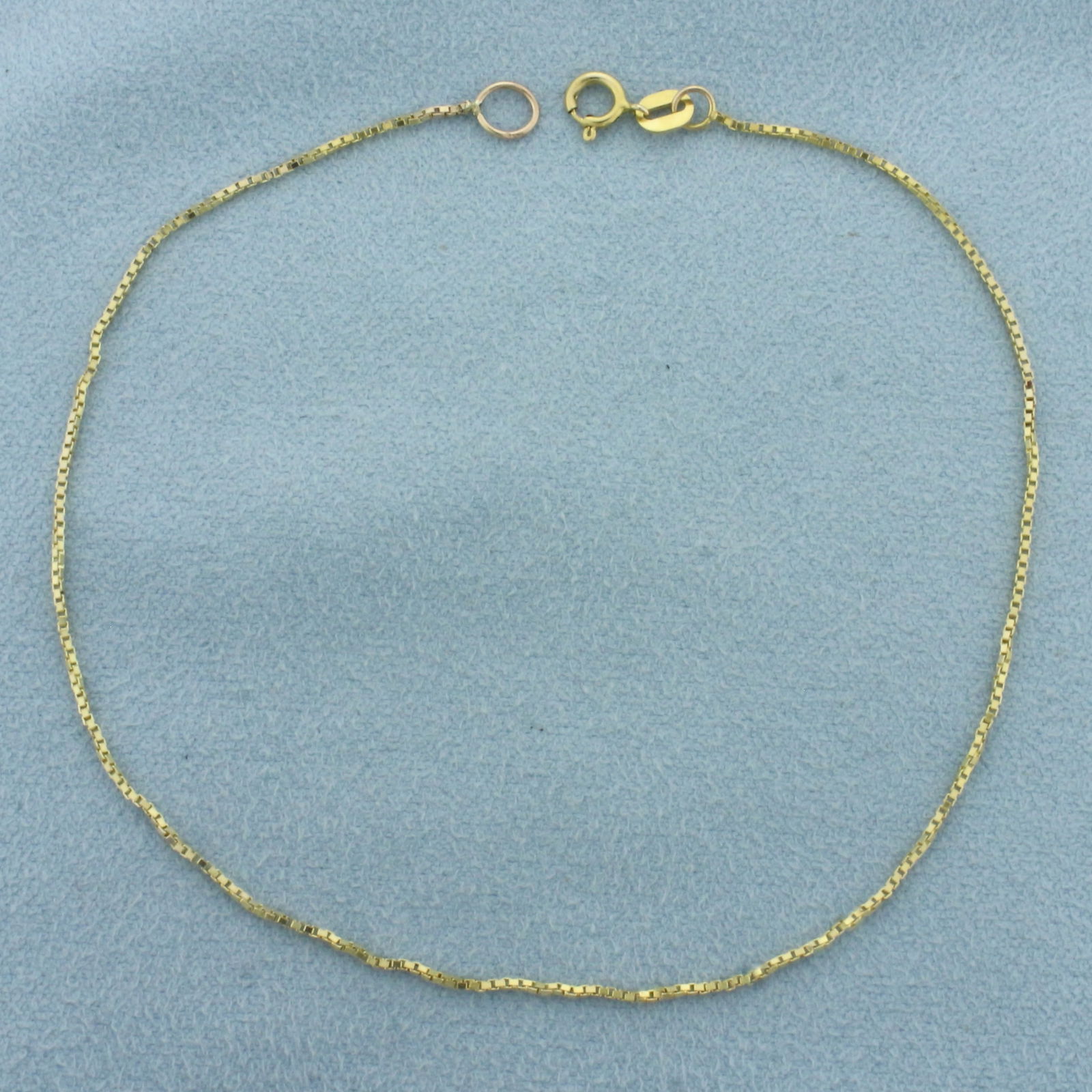 Box Link Anklet in 14k Yellow Gold: In 14k Yellow Gold. 9 1/8 inch long and .7mm wide. Spring clasp.