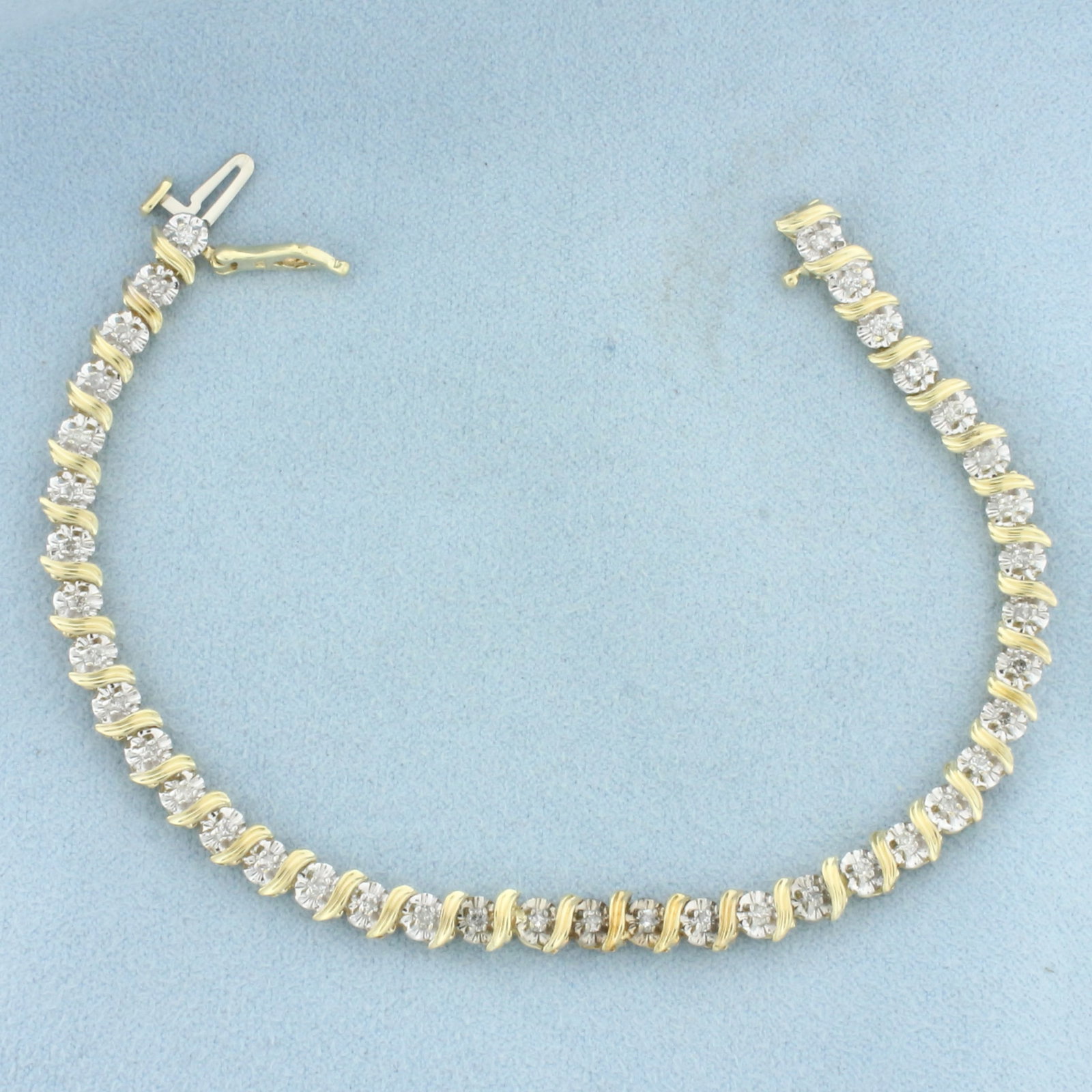 Diamond Tennis Bracelet in 10k Yellow Gold: In 10k Yellow Gold. Contains thirty-nine high quality diamonds, 1/2ct TW, I color/I clarity. 7 inches long. 1/8 inch wide. Concealed slide clasp with safety latch. 8.5g.