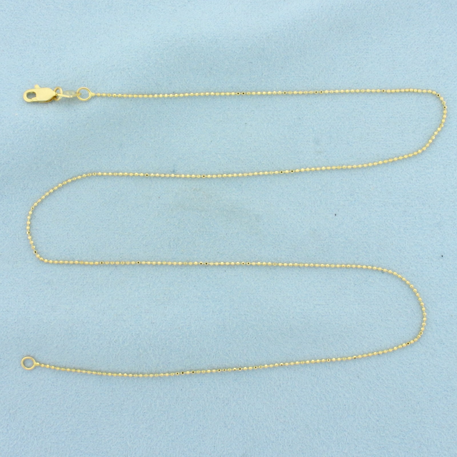 17 Inch Italian Beveled Bead Link Chain Necklace in 14k Yellow Gold: In 14k Yellow Gold. 17 inches long. .9mm wide. Italian made. Beveled beads give extra sparkle. Lobster clasp. 1.8g.