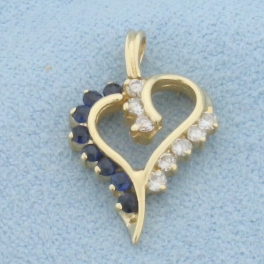 Diamond and Sapphire Heart Pendant in 14k Yellow Gold: In 14k Yellow Gold. Contains eight high quality natural 1.5mm Sapphire gemstones with intense color and excellent clarity. Also contains eight high quality .01ct diamonds, SI clarity/I color. 3/4 inch