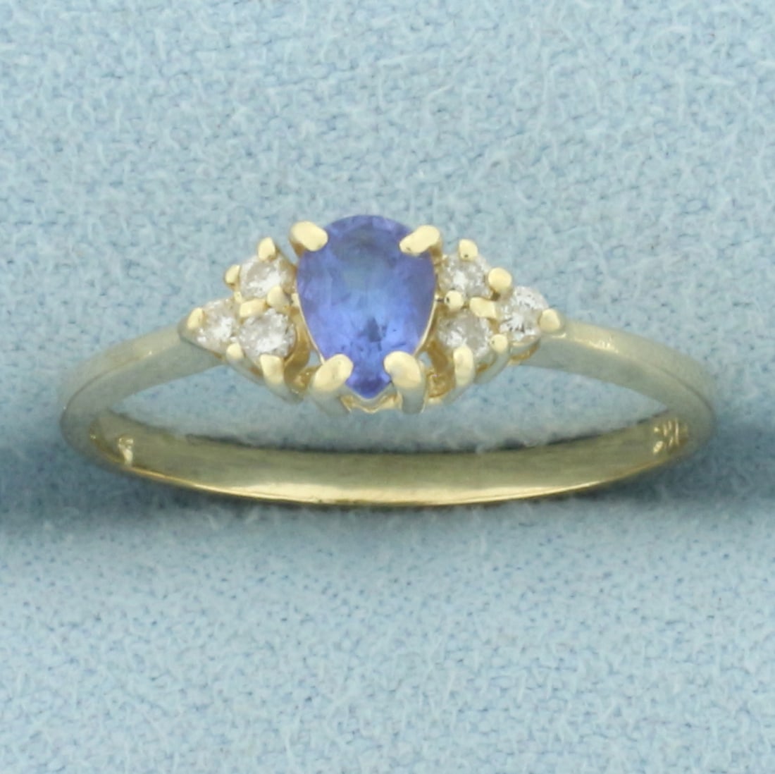 Sapphire and Diamond Ring in 14k Yellow Gold: In 14k yellow gold. Contains one high quality natural 5mm by 4mm Sapphire gemstone with intense color and excellent clarity. Also contains six high quality .01ct diamonds, SI clarity/H color. Size: 7.
