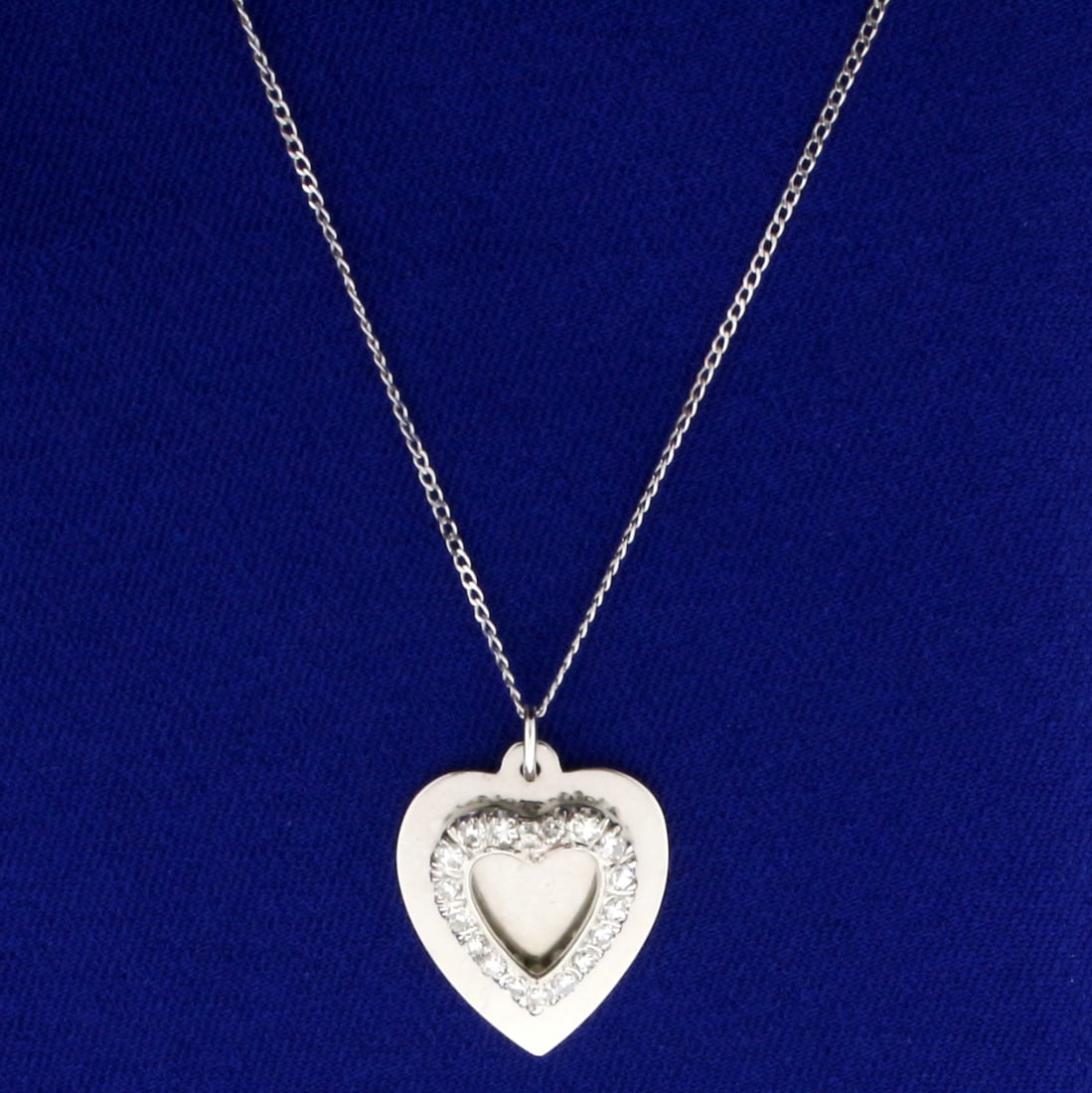 1/3ct TW Diamond Heart Pendant with Chain in 14K White Gold: In 14K White Gold. Contains seventeen high quality .02ct Diamonds, VS clarity/H color. 18 inch long cable link chain. Pendant measures 1 inch long with bale. 3.7g