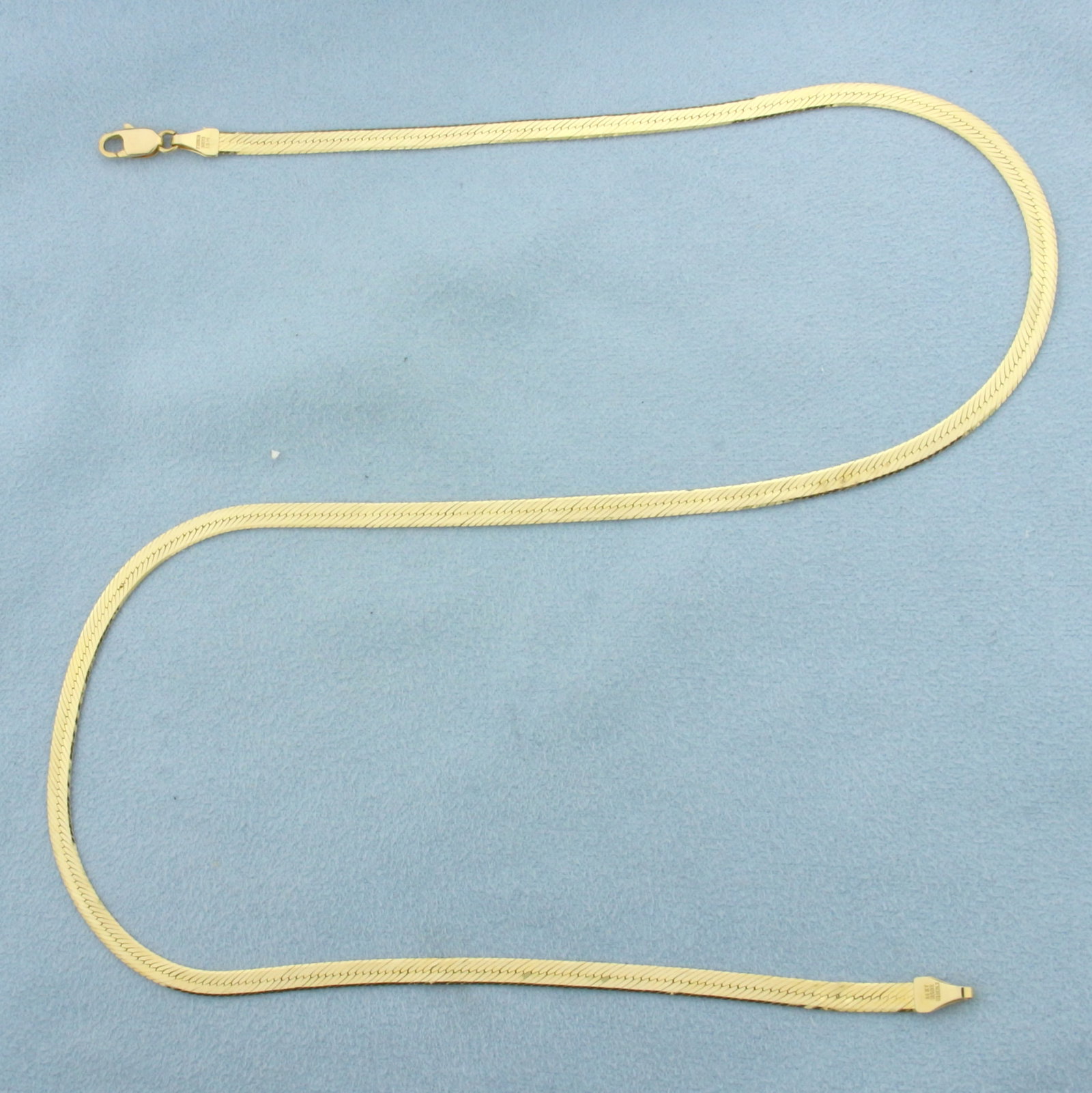 Italian Herringbone Link Chain Necklace in 14k Yellow Gold: In 14k Yellow Gold. 18 inches long. 3.5mm wide. Italian made. Lobster clasp. 5.6g.