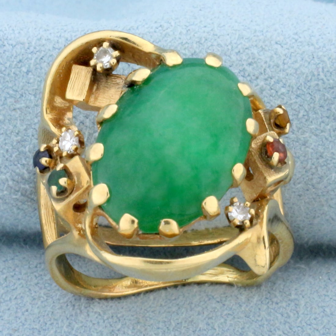 Vintage Jade, Ruby, Sapphire, Emerald, and Diamond Statement Ring in 14K Yellow Gold: In 14K Yellow Gold contains one high quality natural 16.5 x 12mm oval cut Jade gemstone with bright green color. Also contains one high quality natural 2mm Ruby, Citrine, Emerald, and Sapphire gemston