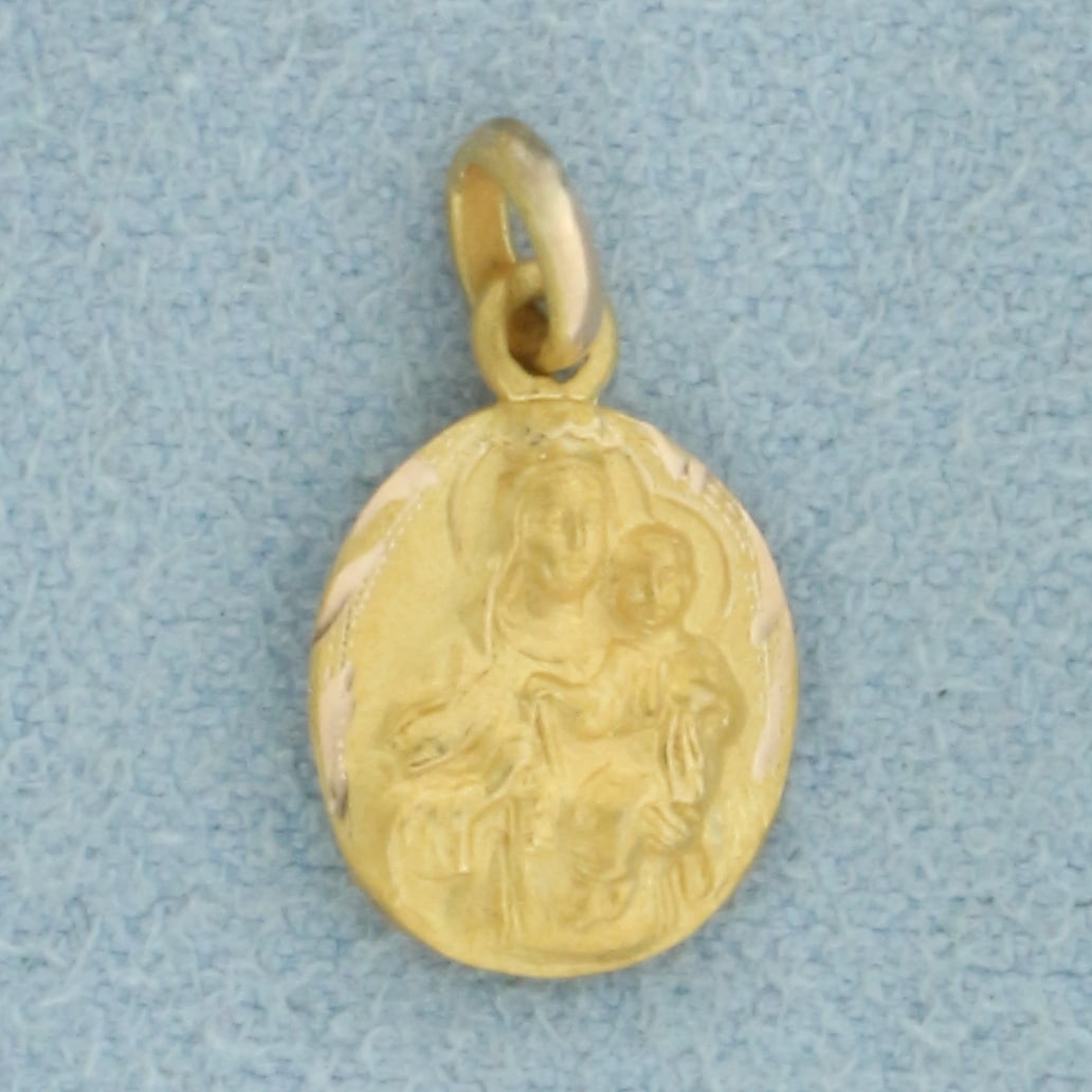 2-Sided Mary and Jesus Charm in 10k Yellow Gold: In 10k Yellow Gold. 5/8 inch long including jump ring. 3/8 inch wide. .6g.
