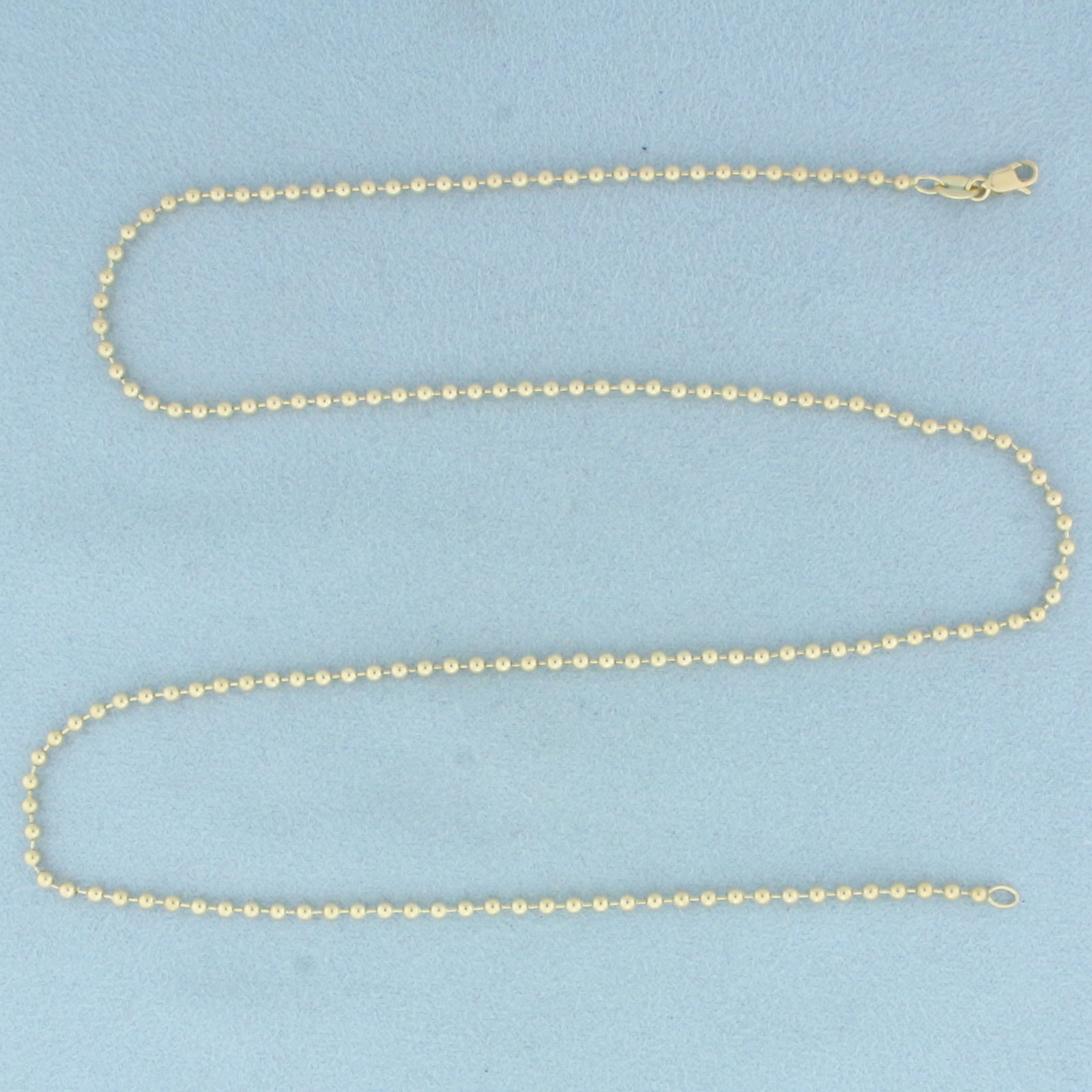 18 Inch Ball Bead Link Chain in 14k Yellow Gold: In 14k Yellow Gold. 18 inches long. 2mm beads. Lobster clasp. 4.9g.
