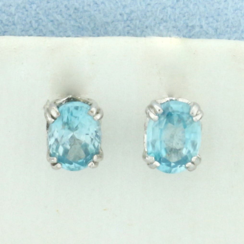 Blue Topaz Stud Earrings in Sterling Silver: In .925 sterling silver. Contains two high quality natural 5mm by 7mm Blue Topaz gemstones with vibrant color and excellent clarity. Friction backs. 1.6g.