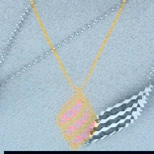 Italian Ruby Abstract Necklace in 14k Yellow Gold: In 14k Yellow Gold. Contains nine 2mm high quality natural Ruby gemstones with intense color and excellent clarity. Pendant is 5/8 inch long by 3/8 inch wide. Box link chain is 18 inches long by 0.7mm