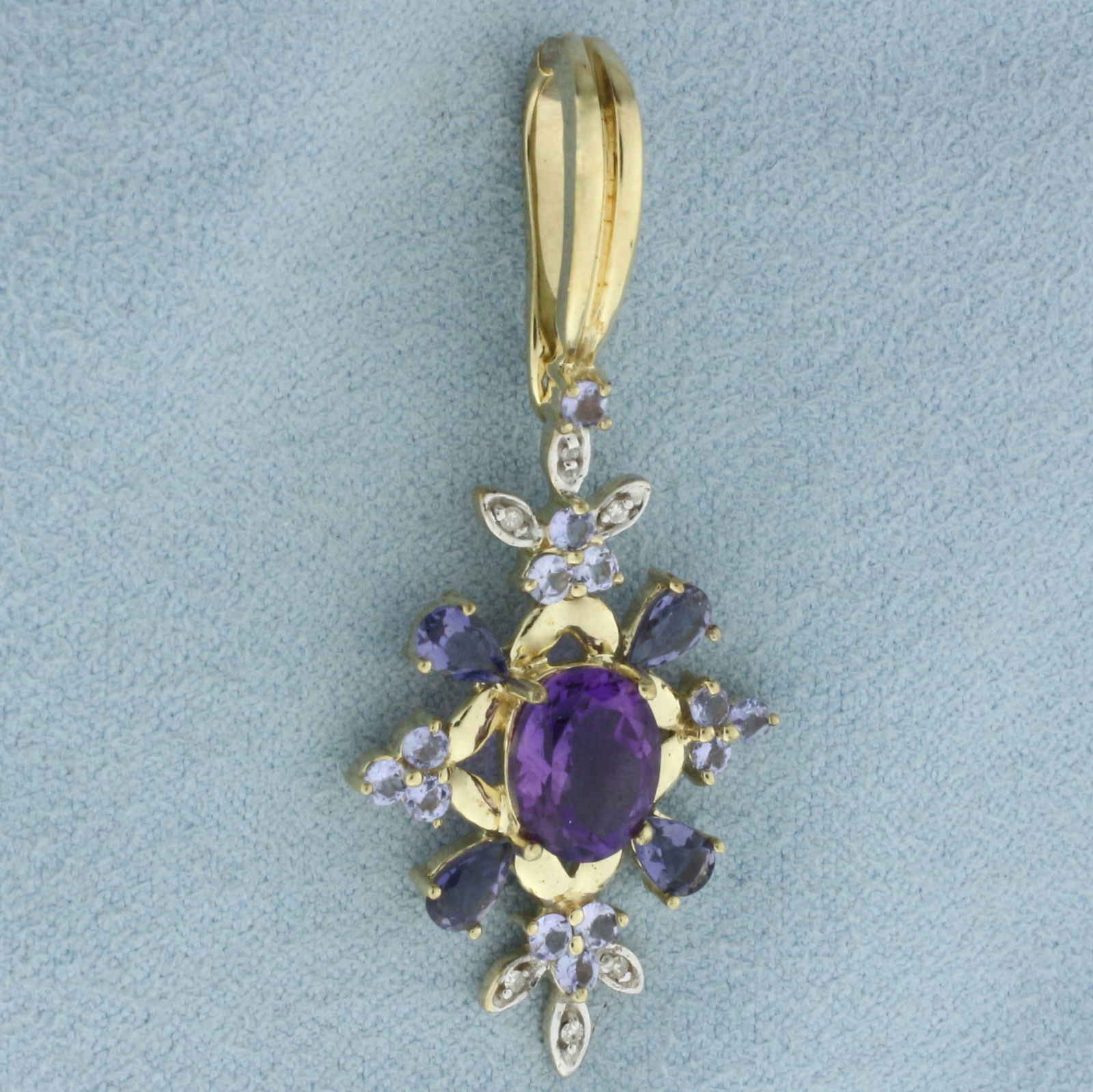 Aquamarine, Amethyst, Tanzanite, and Diamond Pendant in 10k Yellow Gold: In 10k yellow gold. Contains one high quality 9mm Amethyst gemstone, approximately 1.75cts, with intense color and excellent clarity. Also contains four high quality 5mm pear cut Tanzanite gemstones a