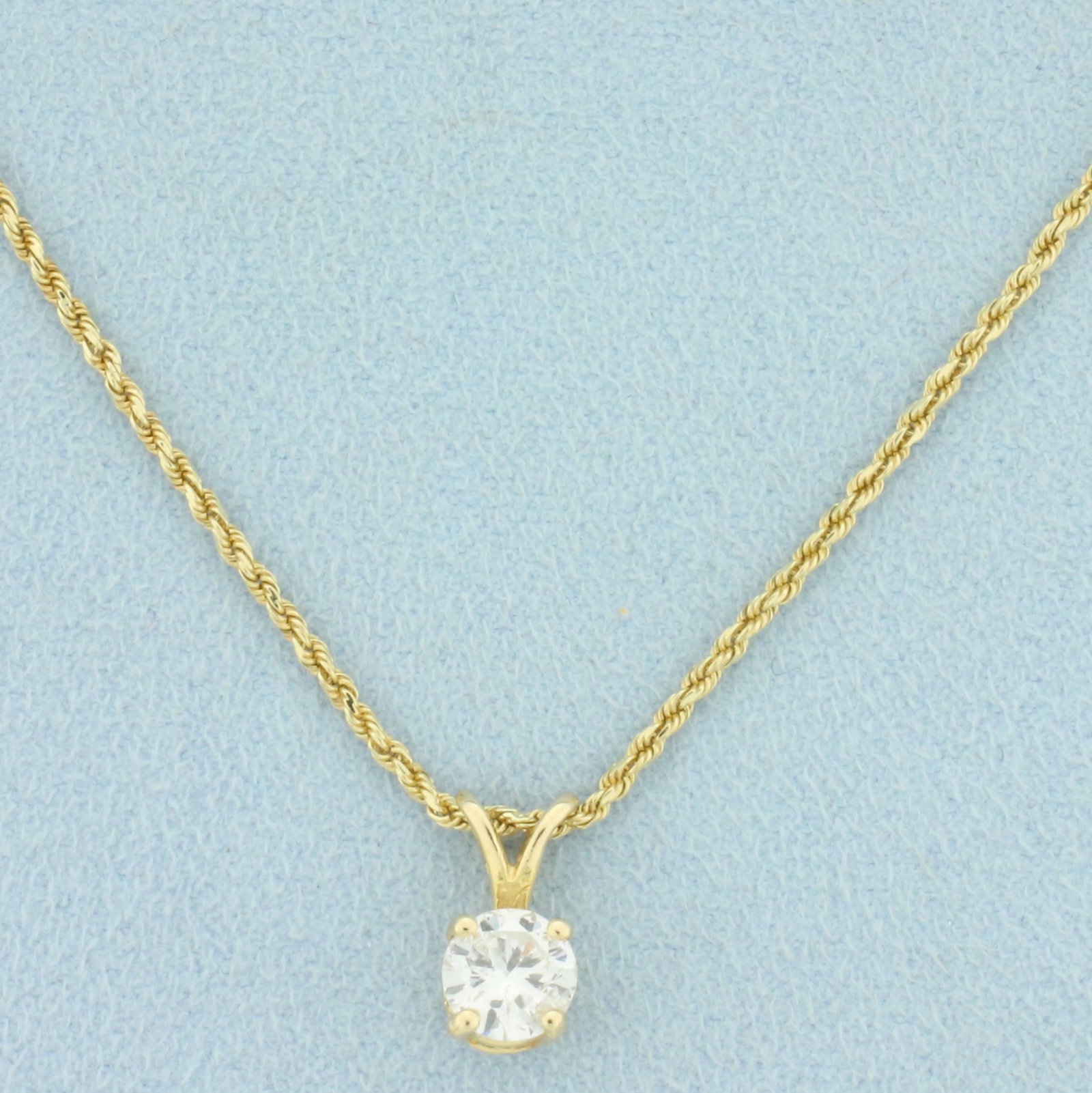 Diamond Solitaire Necklace in 14k Yellow Gold: In 14k yellow gold. Contains one .9ct high quality round brilliant diamond, I1 clarity/I color, great cut for lots of sparkle. Pendant 1/2 inch long. Rope link chain 20.5 inches long, 1.5mm wide, lobs