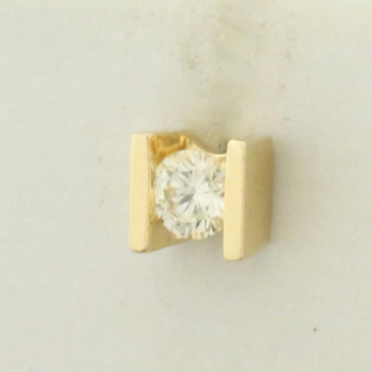 Single Diamond Tension Set Stud Earring in 14k Yellow Gold: In 14k Yellow Gold. Contains one high quality 1/8ct diamond, VS clarity/I color, great cut for added brilliance. Friction back. .6g.