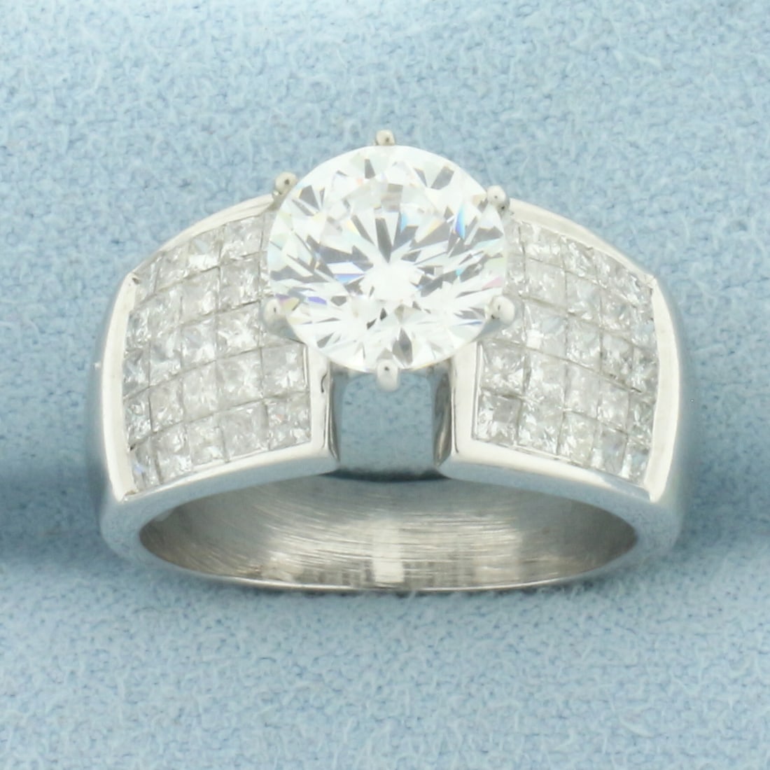 Invisible Set Diamond and CZ Engagement Ring in 14k White Gold: In 14k white gold. Contains one high quality 2ct CZ gemstone with excellent cut and clarity for added brilliance. Also contains fifty high quality princess cut diamonds, 2ct TW, H color/I clarity. Siz