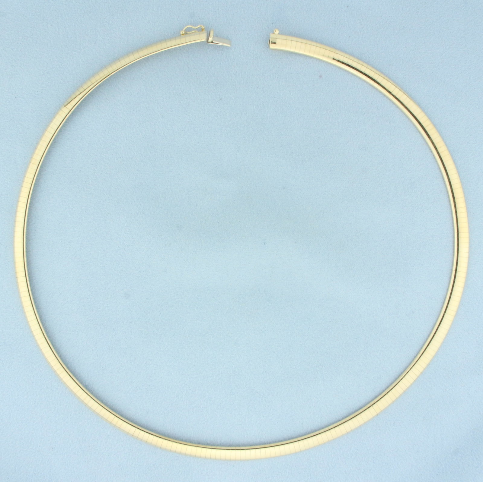 Italian 18 Inch Omega Link Necklace in 14k Yellow Gold: In 14k yellow gold. 18 inches long and 6mm wide,. Concealed slide clasp with safety latch. 38.0g.