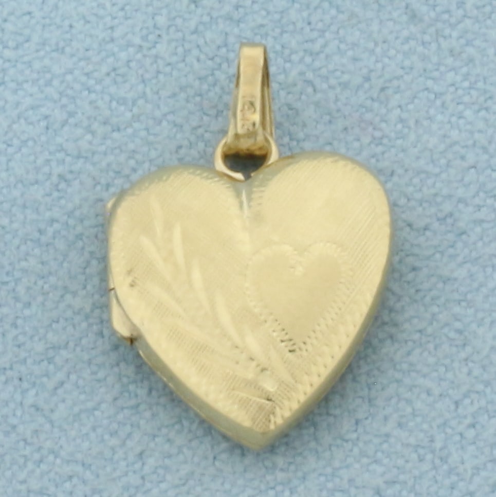 Heart Locket Pendant in 14k Yellow Gold: In 14k Yellow Gold. 3/4 inch long. 1/2 inch wide. 1.2g.