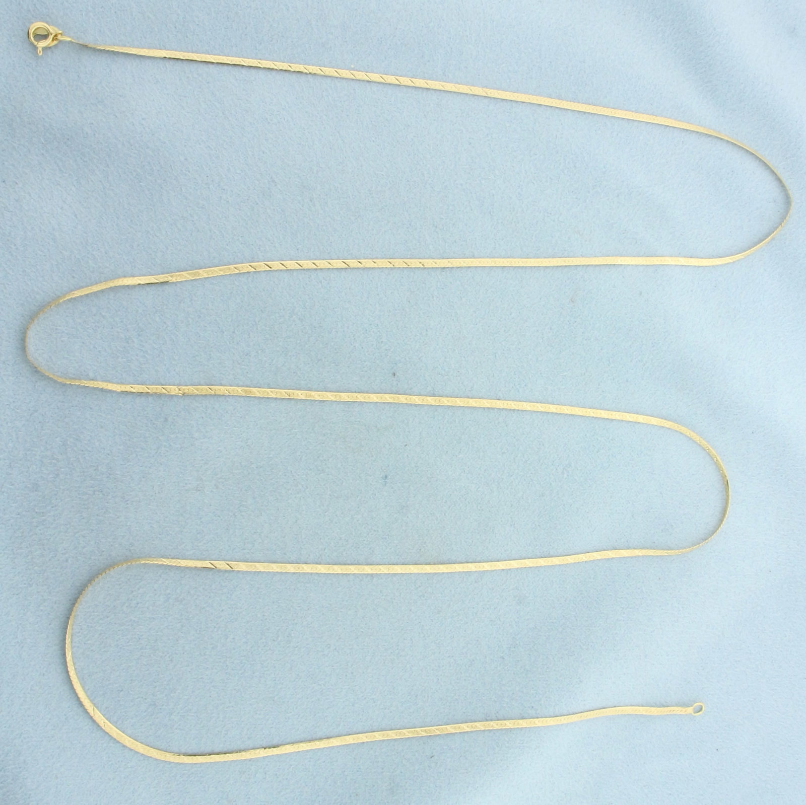 Italian 30 Inch Herringbone Link Chain Necklace in 18k Yellow Gold: In 18k Yellow Gold. 30 inches long. 1.5mm wide. Italian made. Sandblast and diamond cut design. Spring clasp. 4.0g.