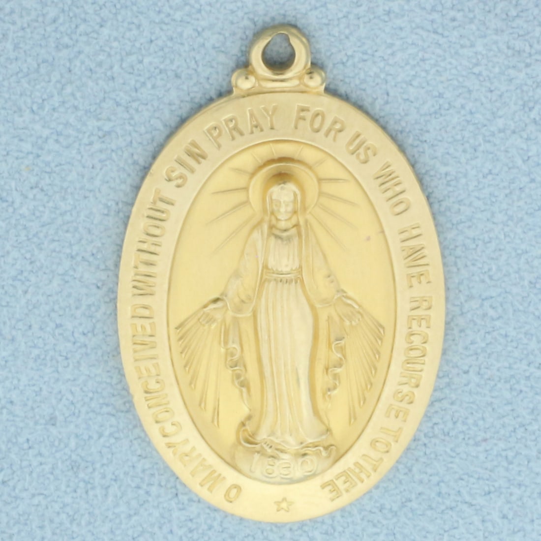Large Miraculous Medal Virgin Mary Pendant in 14k Yellow Gold: In 14k yellow gold. 1 1/4 inches long and 3/4 inches wide. 6.0g.