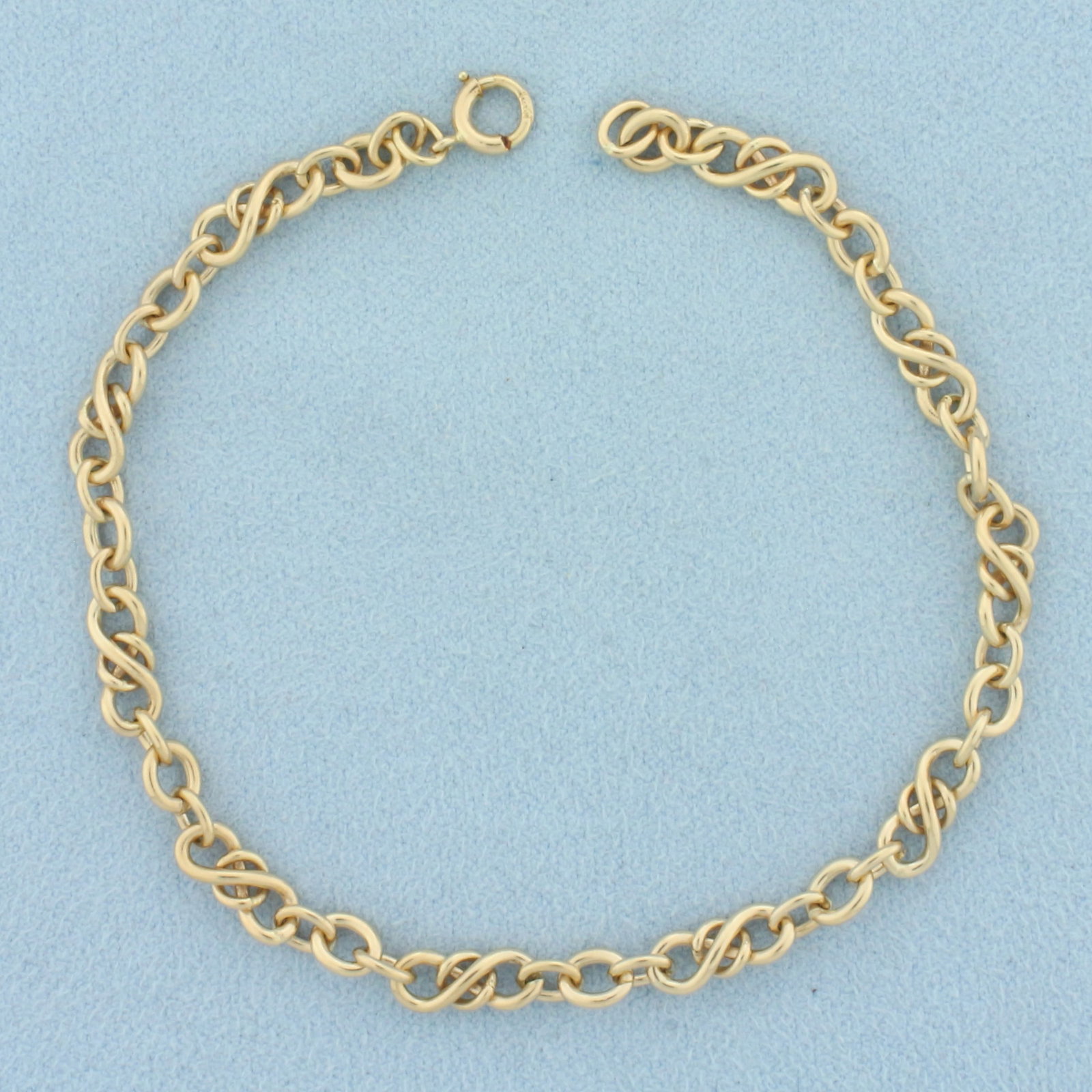 Love Knot Link Bracelet in 14k Yellow Gold: In 14k yellow gold. 7 5/8 inches long and 4.5mm (at widest). Spring clasp. 7.8g.