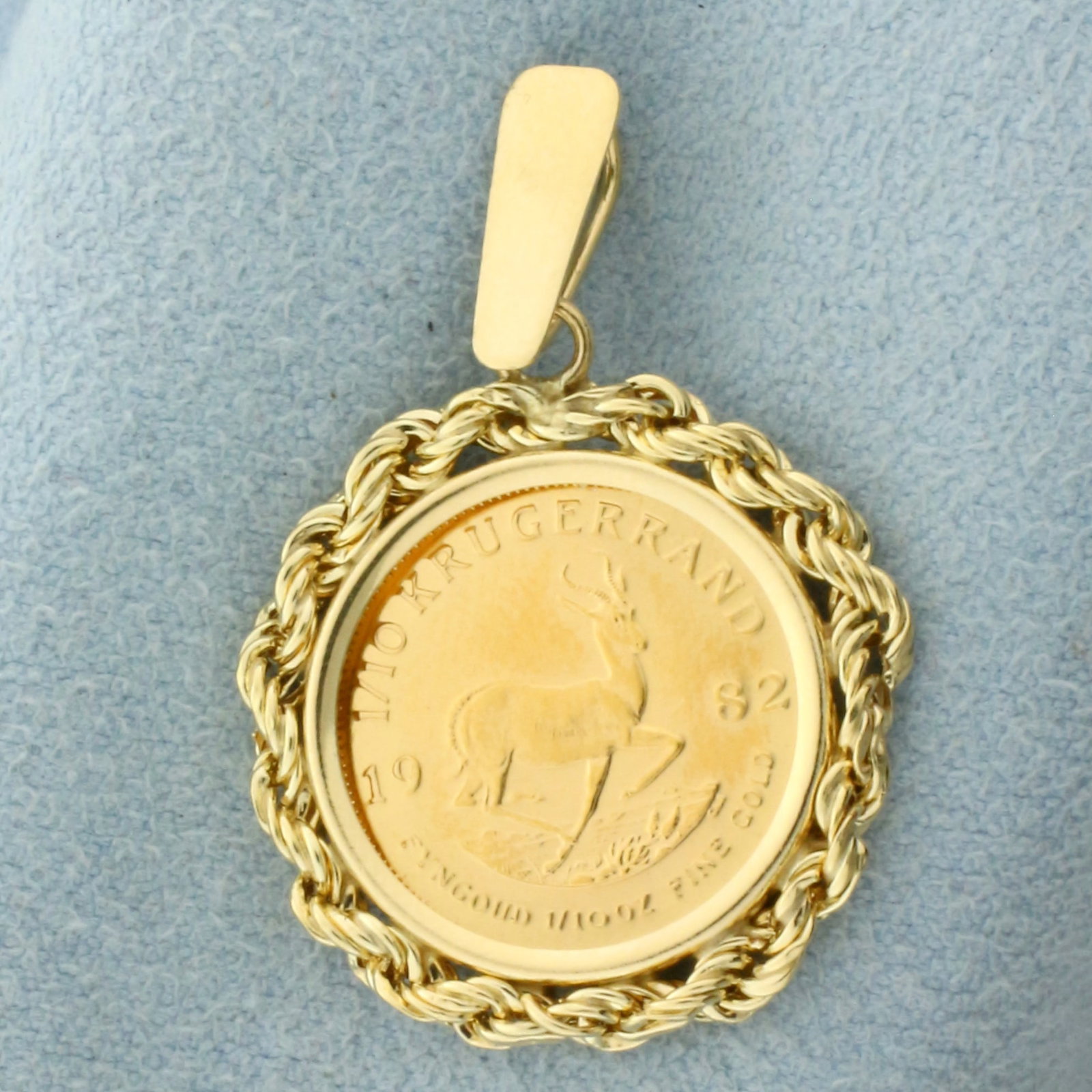 Krugerrand Coin Pendant in 14k Yellow Gold Coin Bezel: In 14k Yellow Gold Coin Bezel Mounting. Contains one 1982 1/10th ounce gold Krugerrand coin. 1 1/4 inch long including bale. 3/4 inch wide. 4.4g.