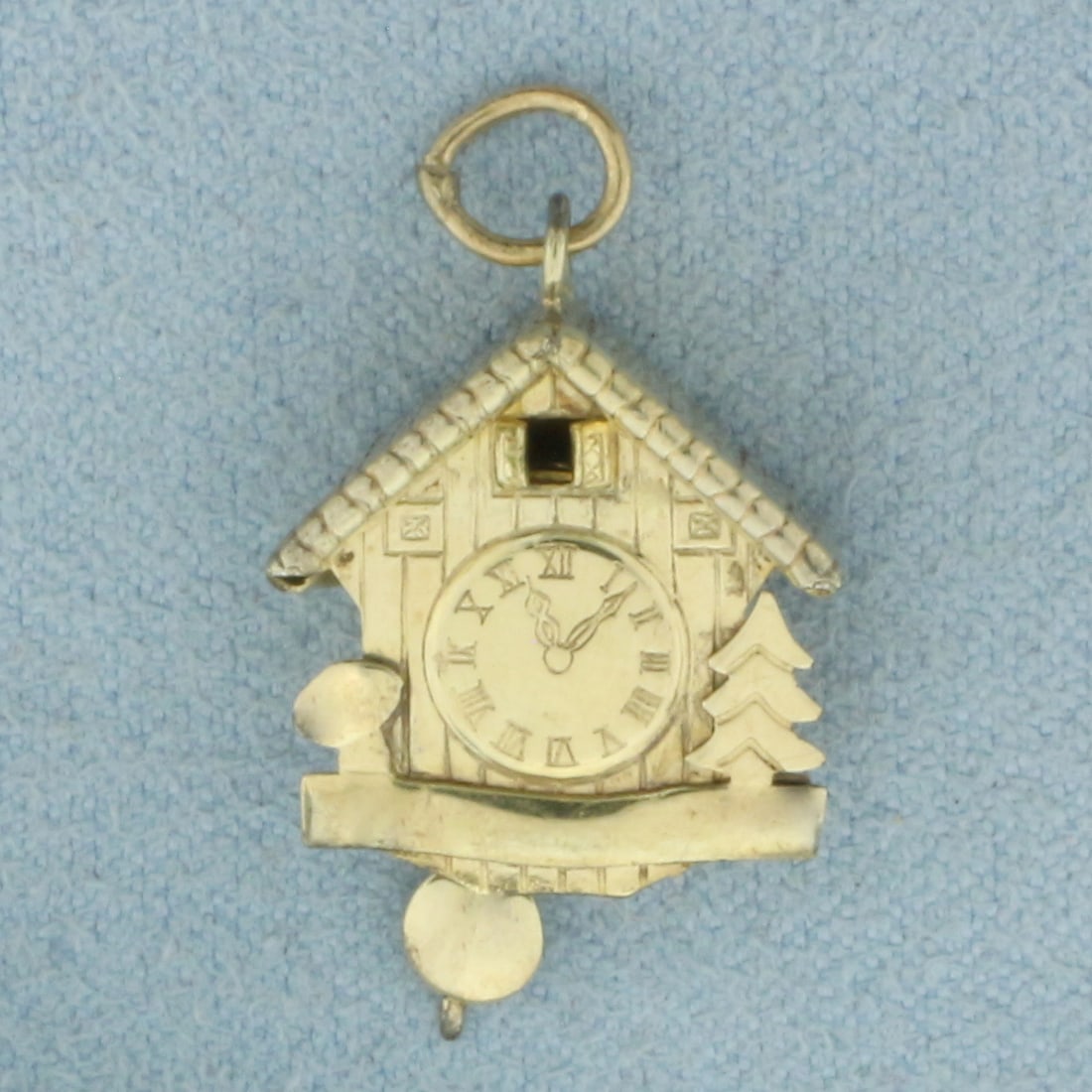 Vintage Mechanical Cuckoo Clock Charm in Gold Plated Silver: In gold plated .800 silver. 1 inch long including jump ring. 1/2 inch wide. Pendulum swing back and forth. 2.1g