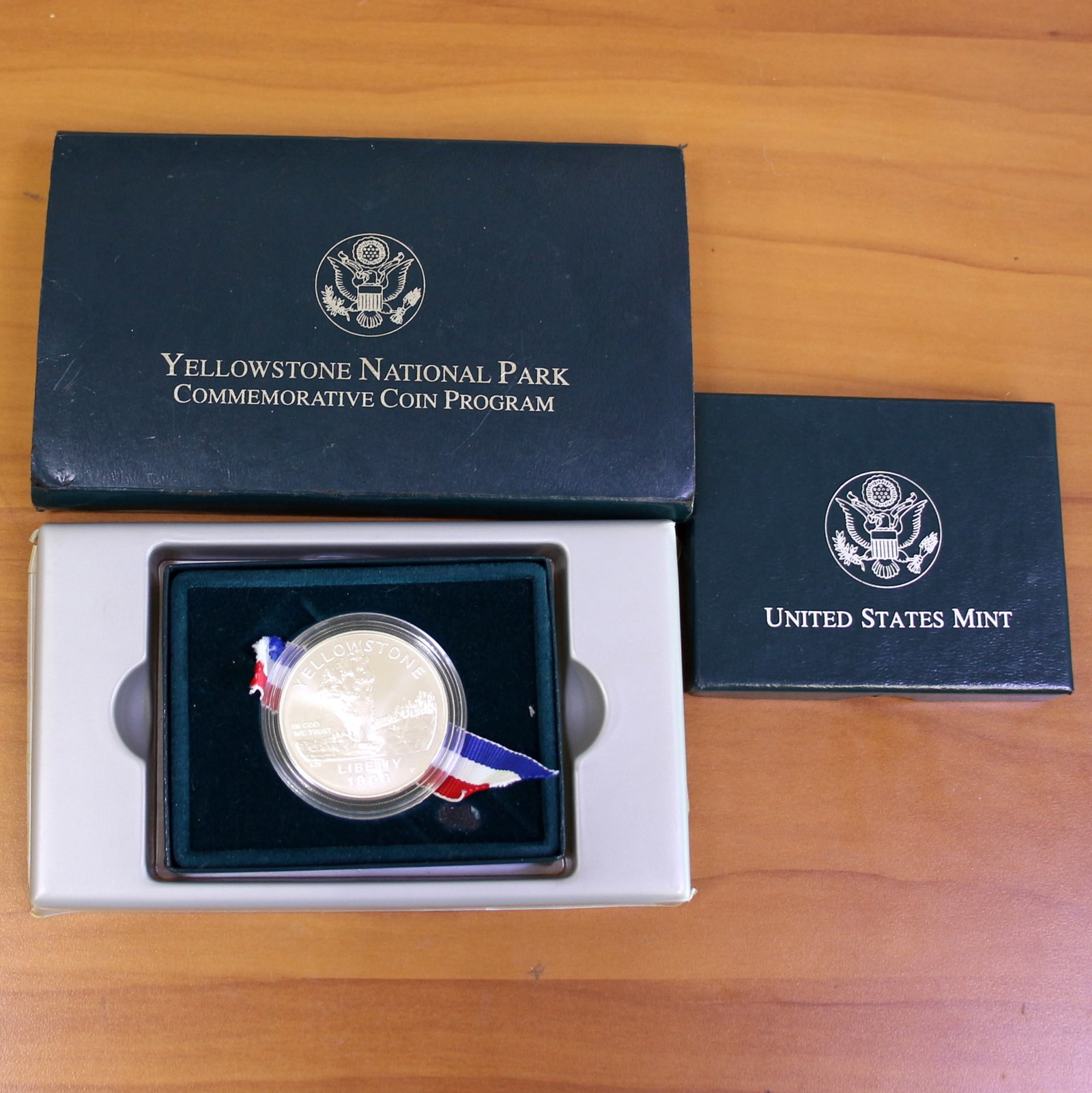1991 U.S. Mint Yellowstone National Park Proof Silver Coin OGP: 1991 U.S. Mint Yellowstone National Park Commemorative Coin. 90% silver coin. Set in original case and box. Coin is 26.7g.