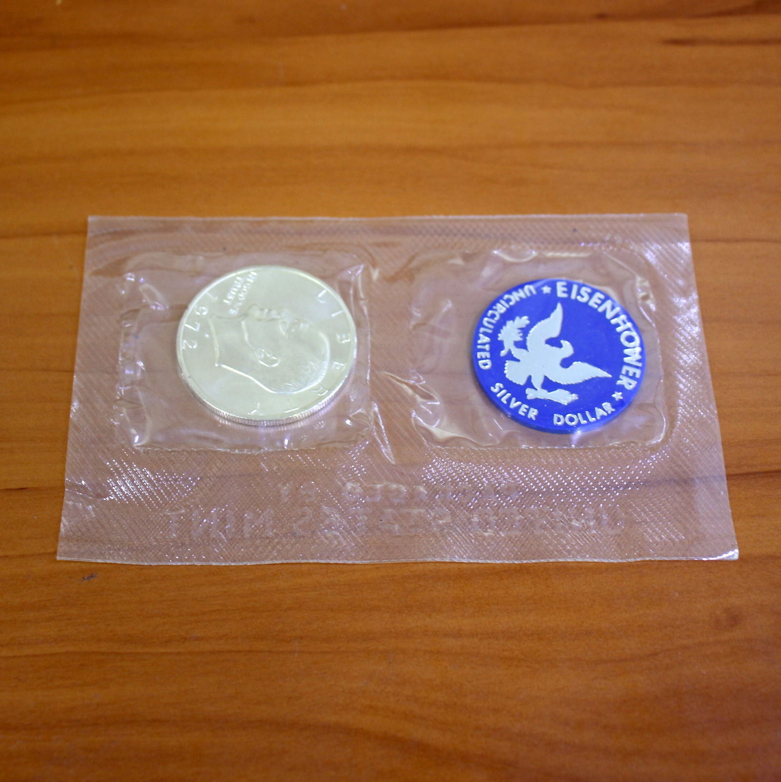 Uncirculated Eisenhower Silver Dollar Coin OGP: Uncirculated Eisenhower Silver Dollar. One from 1971-1973. Set in original government plastic casing.