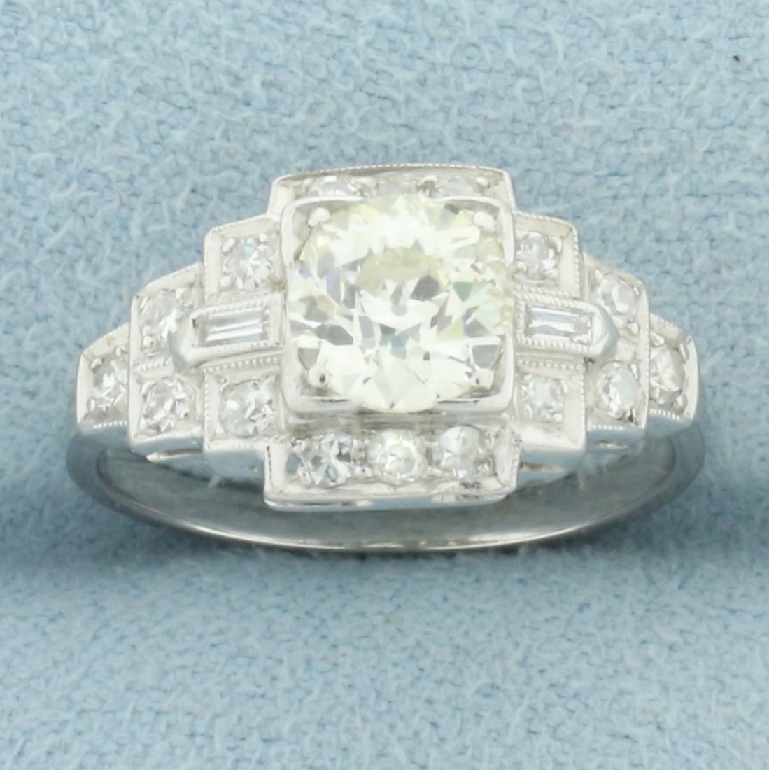 Antique Art Deco Old European Cut Diamond Ring in Platinum: In Platinum. Contains one high quality .9ct old European cut diamond, VS clarity/J color. Accented with 16 round and 2 baguette diamonds, 1/3ct TW, of similar high quality. Size:5.