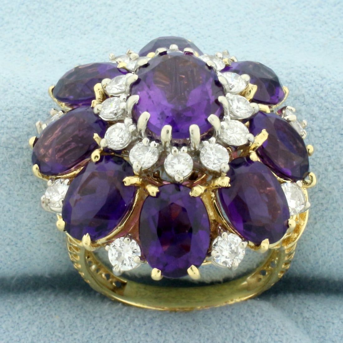 Amethyst and Diamond Flower Statement Ring in 18k Yellow Gold: In 18k yellow gold. Contains one 2.4ct and eight 1.25ct high quality natural oval amethyst gemstones with vibrant color and excellent clarity, approximately 13ct TW. Also contains eight 1/8ct and twel