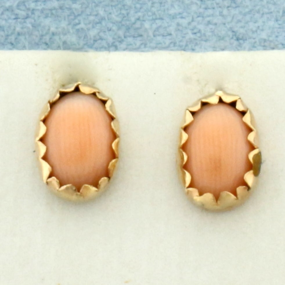 Vintage Angelskin Pink Coral Stud Earrings in 14k Yellow Gold: In 14k Yellow Gold. Contains two high quality 8mm angelskin Pink Coral gemstones with vibrant color. Friction backs. .9g.