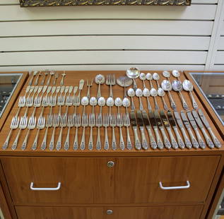 International Queen's Lace Seventy Nine Piece Sterling Silver Flatware Set: In Sterling Silver. Contains twelve forks @ 7 1/4 inches. Twelve salad forks @ 6 1/2 inches. Fourteen teaspoons @ 6 inches. Twelve modern knives @ 9 1/4. three large solid serving tablespoons @ 8 1/2
