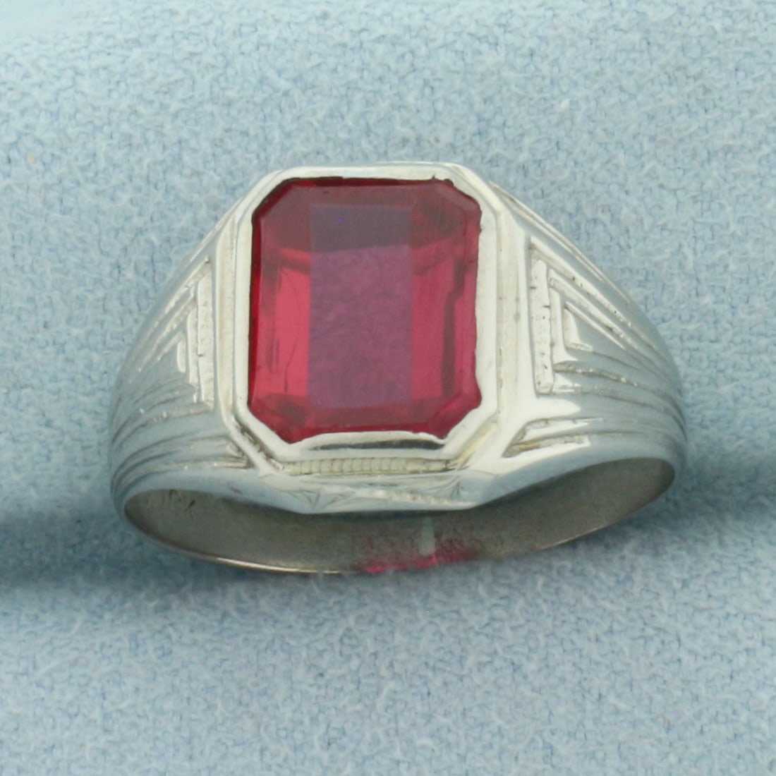 Mens Vintage Lab Ruby Ring in 10k White Gold: In 10k White Gold. Contains one 11mmx9mm high quality Lab Ruby gemstone with intense color and excellent clarity. 12.4mm wide at center. Size 9. 3.3g.