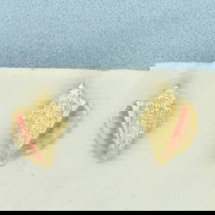 Enamel Conch Shell Earrings in 14k Yellow Gold: In 14k Yellow Gold. 1/2 inch long. 3/8 inch wide. Enamel detail to give realistic shell look. Friction backs. 2.7g.