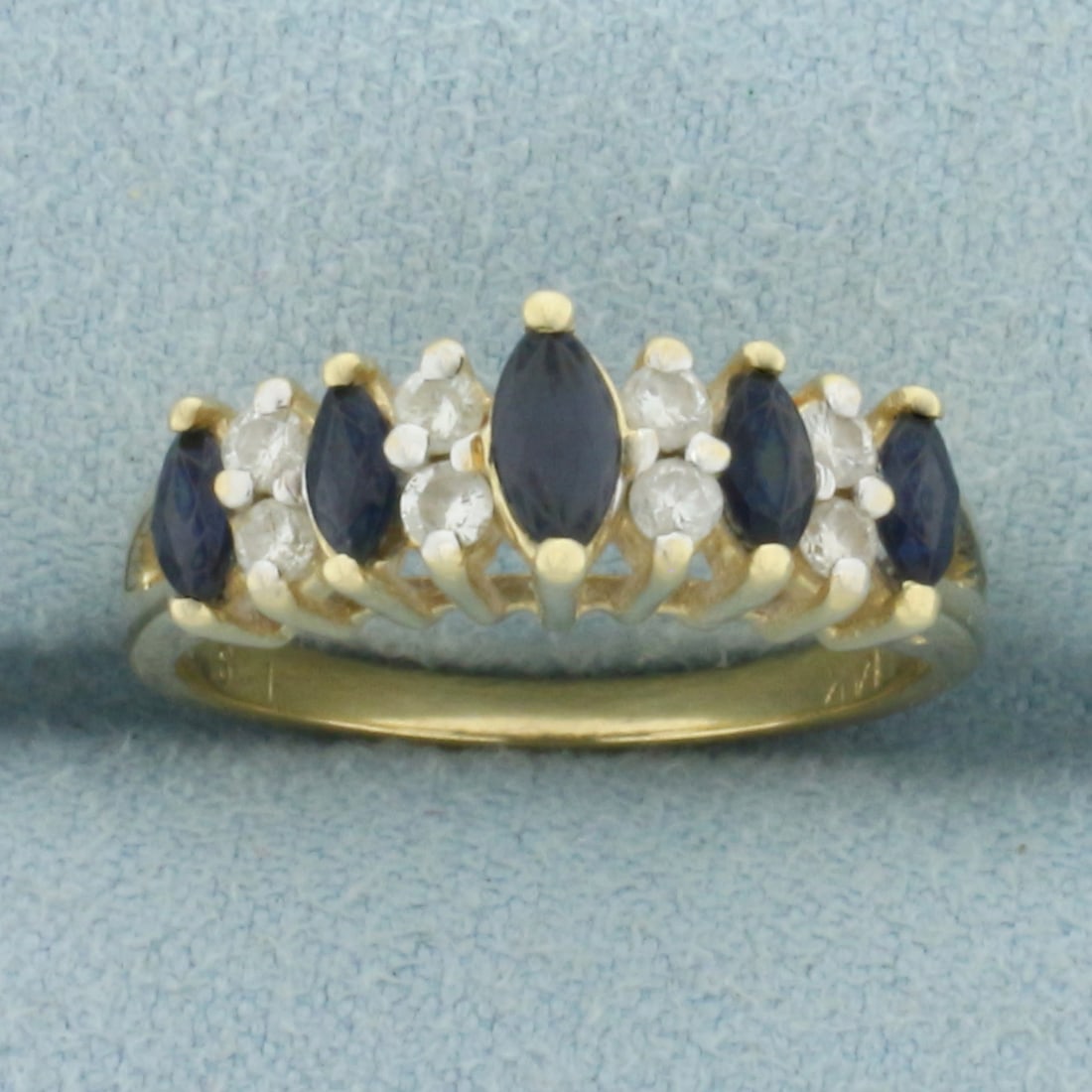 Vintage Marquise Sapphire and Diamond Ring in 14k Yellow Gold: In 14k Yellow Gold. Contains one 5.3mm and four 4mm high quality marquise cut natural Sapphire gemstones with deep color and excellent clarity. Also contains eight .02ct high quality diamonds, SI clar