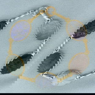 Hand Carved Gemstone Scarab Bracelet in 14k Yellow Gold: In 14k yellow gold. Contains five high quality 18 by 13mm gemstones including lapis lazuli, jade, chalcedony, quartz, and moonstone. 7 1/4 inches long and 1/2 inches wide. Spring clasp. 16.4g.