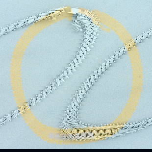 Diamond Designer Link Bracelet in 14k Yellow Gold: In 14k yellow gold. Contains seven .05ct high quality diamonds, H color/I clarity. 7 1/2 inches long, 9mm wide at widest point. Slide clasp with safety latch. 15.1g.