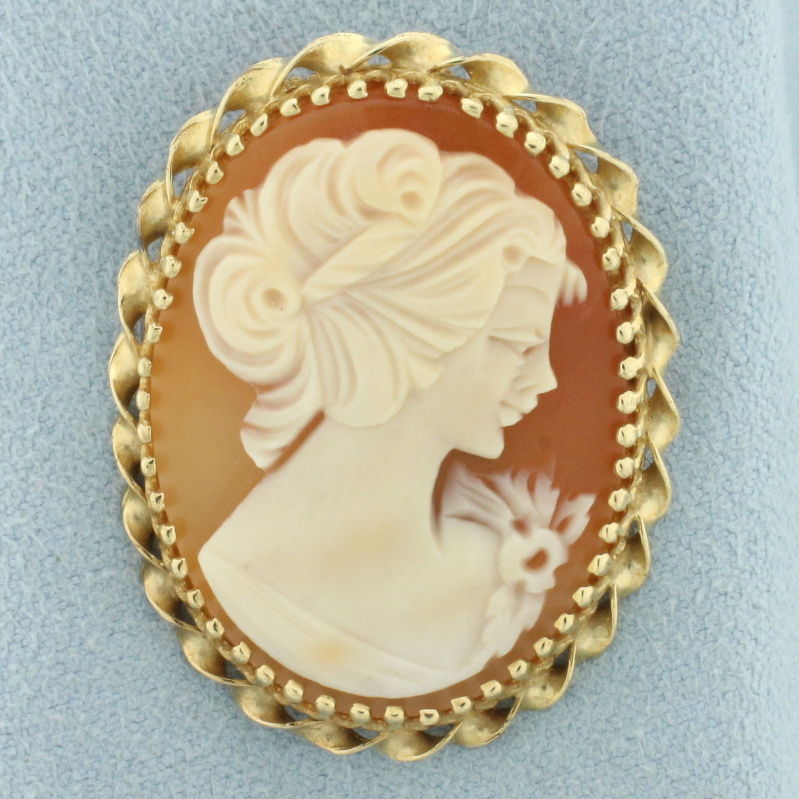 Carved Shell Right Facing Cameo Pendant Brooch Pin in 14k Yellow Gold: In 14k yellow gold. 1 3/8 inches long and 1 inch wide. Can be worn as pendant or brooch pin. 6.5g.