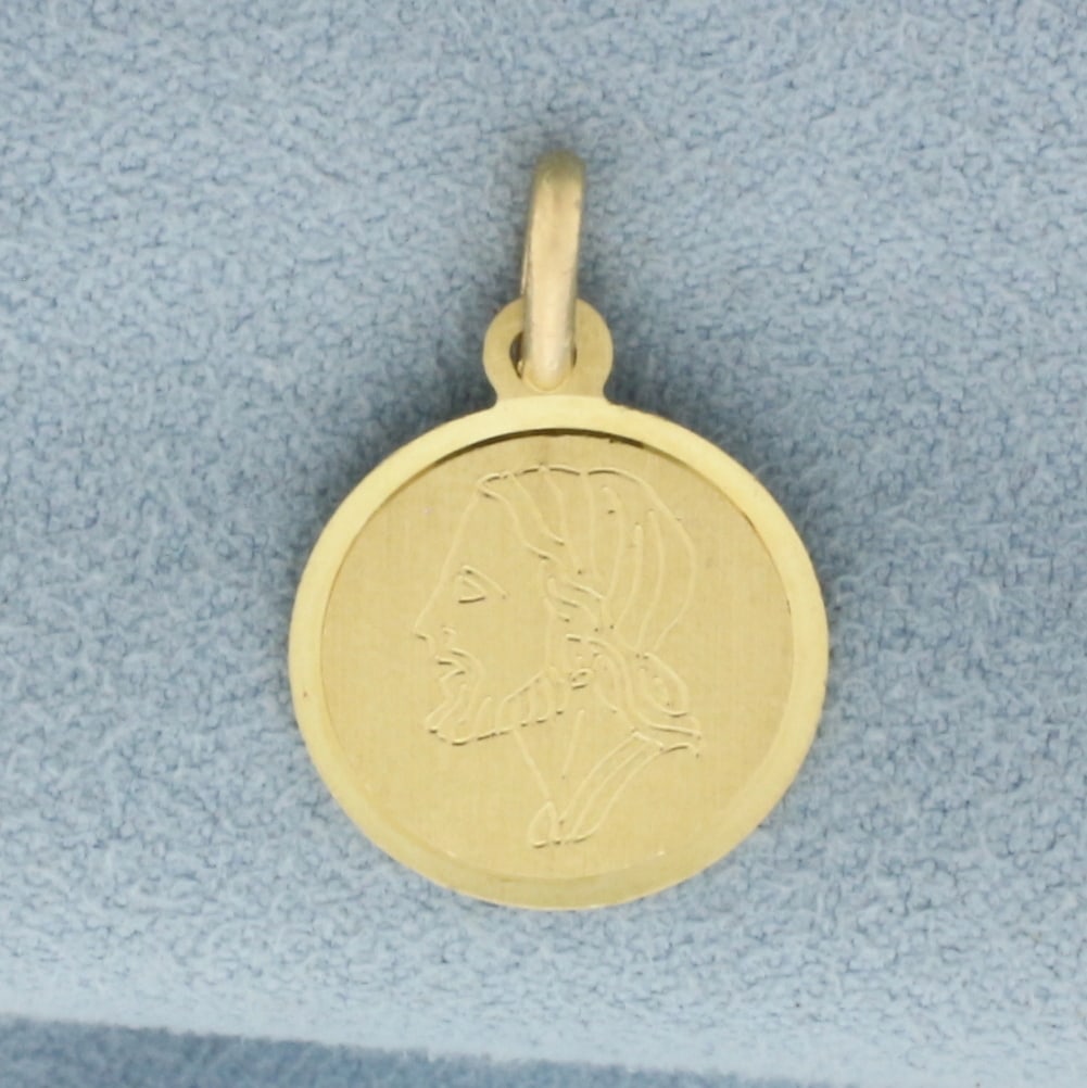 Jesus head Pendant or Charm in 14k Yellow Gold: In 14k Yellow Gold. 7/8 inch long, 1/2 inch wide. 1.3g.