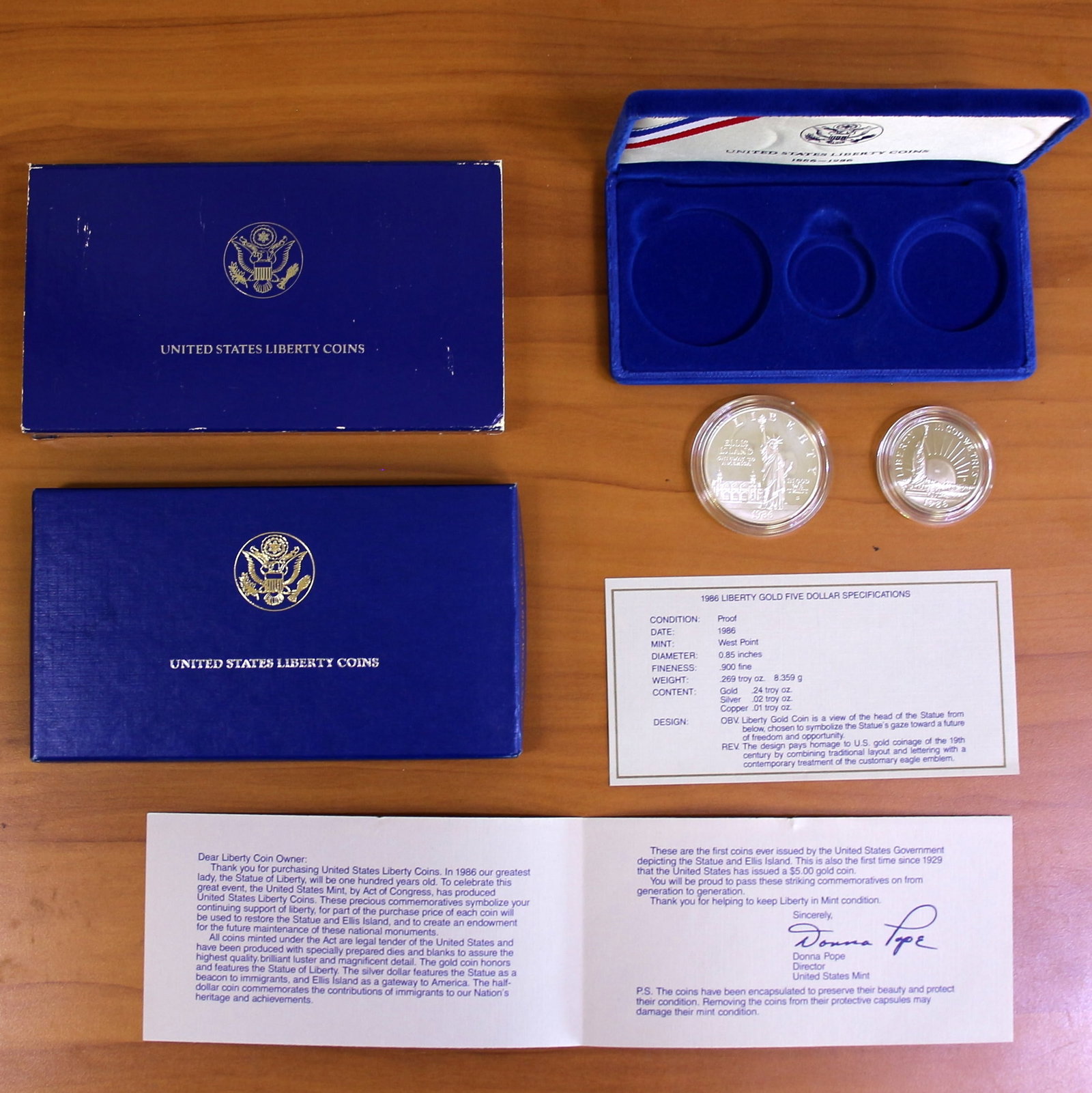 US Mint Liberty Silver Dollar Coin Proof Set OGP 1986: 1986 US Mint Liberty Coin Proof Set. Contains two coins - Silver Dollar and Half Dollar, does not include gold five dollar coin. Includes CoA, government packaging, and box.