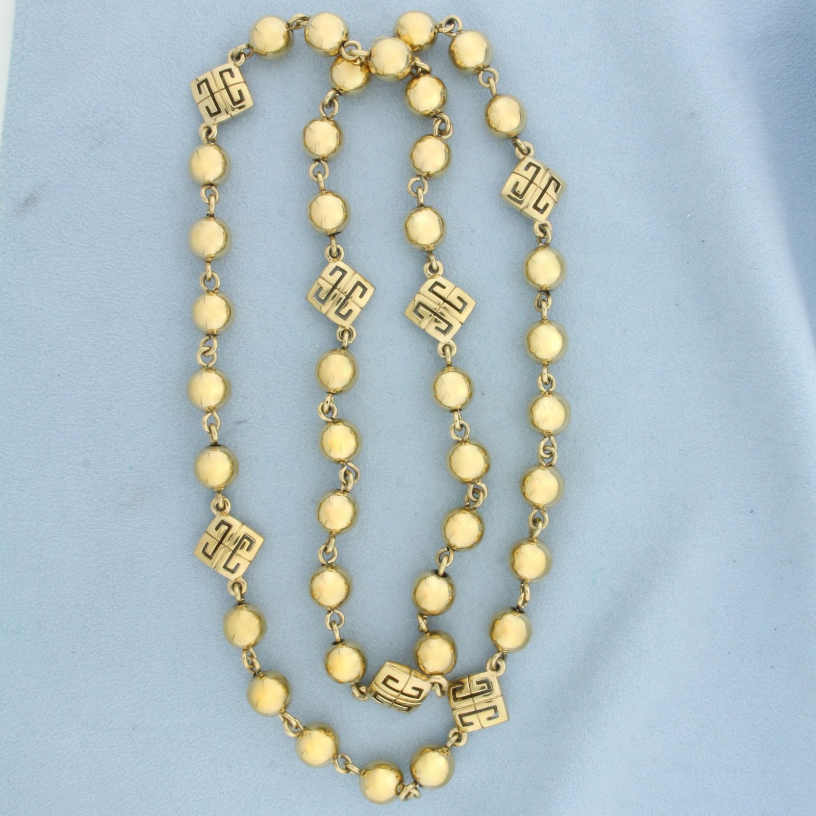 Vintage Givenchy Logo Ball Bead Necklace: Gold Plated. 30 inches long. 10mm ball beads.
