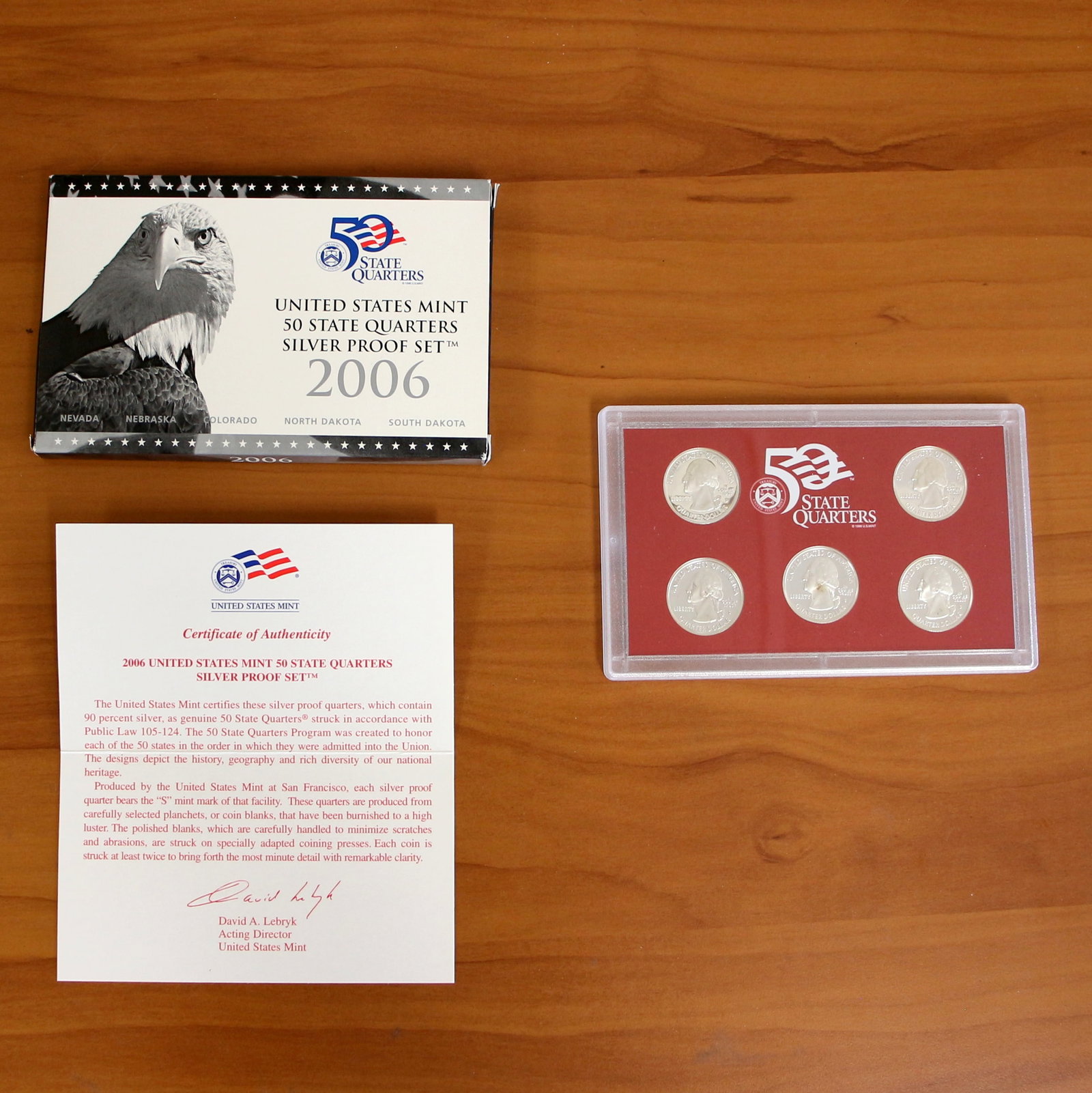 U.S. Mint State Quarters Silver Proof Coin Set OGP COA: 1 Set from 2004 to 2006. Includes five proof silver quarters. Includes original box, casing, and CoA.
