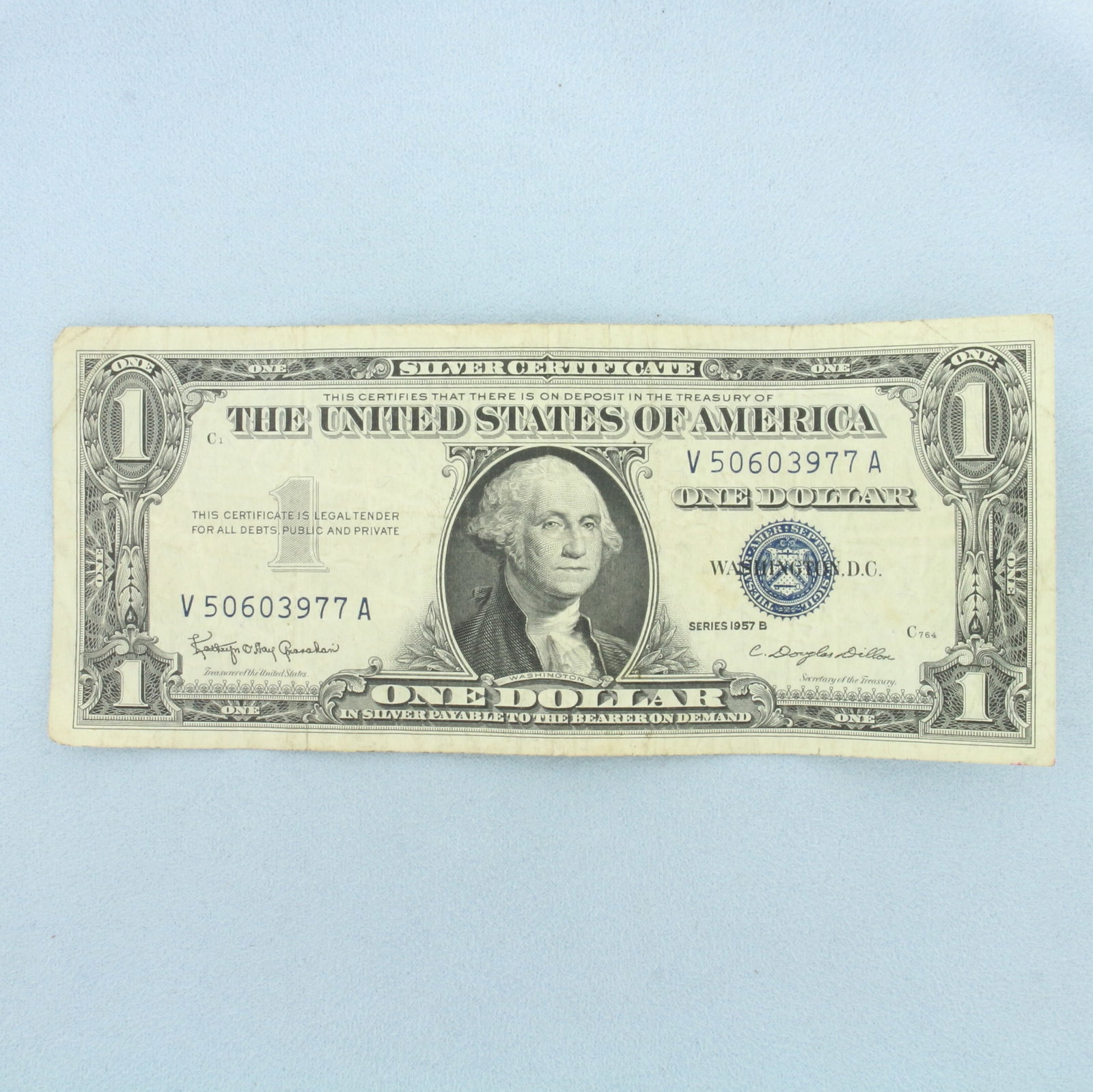 1957 $1 Silver Certificate Blue Seal Bill: $1 One Dollar Silver Certificate banknote with a blue seal, circulated condition. No rips or tears on note, typical circulated condition.