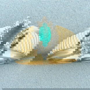 Emerald and Diamond Ring in 14k Yellow Gold: In 14k Yellow Gold. Contains one high quality natural 7mmx3.3mm marquise Emerald gemstone with vibrant color and excellent clarity. Also contains fourteen .01ct diamonds, SI clarity/H color. 12mm wide