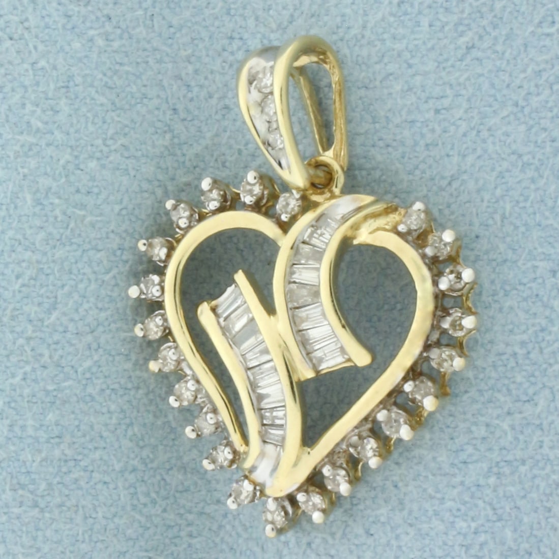 Diamond Heart Pendant in 10k Yellow Gold: In 10k Yellow Gold. Contains twenty-six round and sixteen baguette high quality diamonds, 1/2ct TW, I color/I clarity. 1 1/8 inch long. 3/4 inch wide. 2.7g.